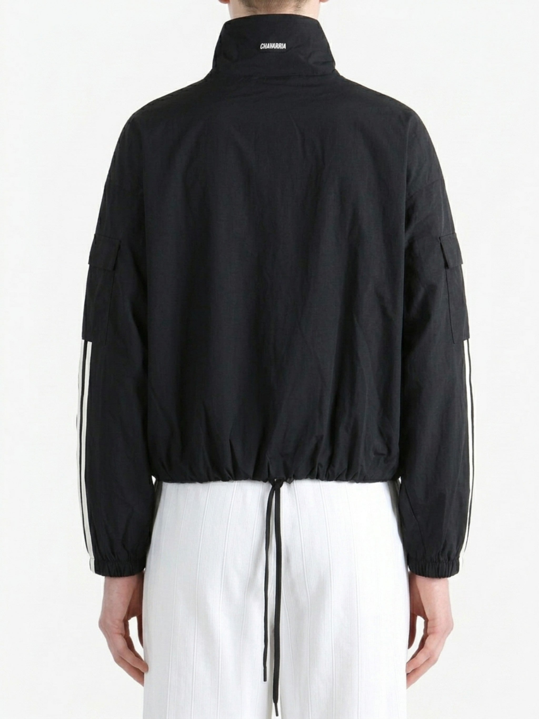 Black jacket worn by a person, back view