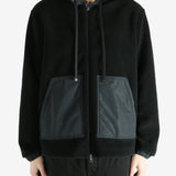 Black cardigan worn by a person, showing the cardigan fit