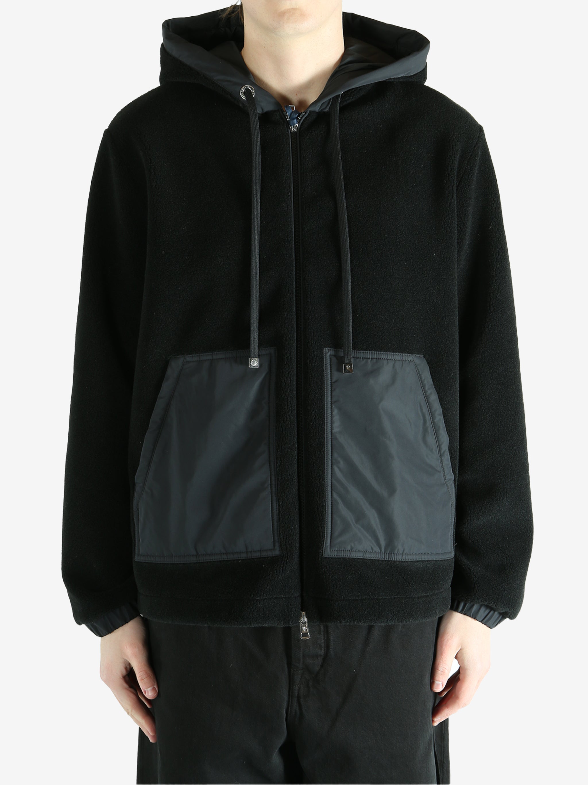 Black cardigan worn by a person, showing the cardigan fit