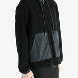 Black cardigan worn by a person, showing the cardigan fit