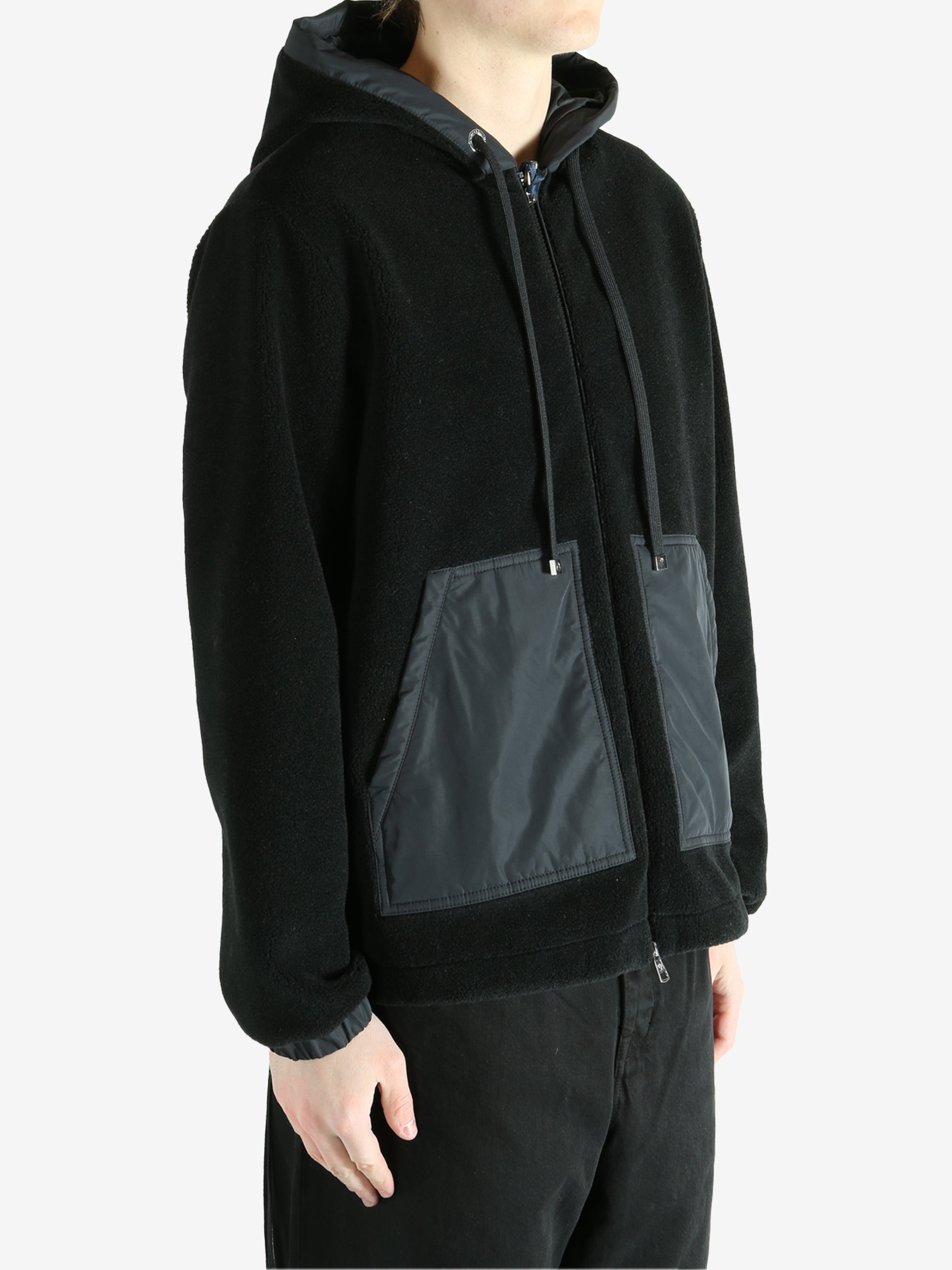 Black cardigan worn by a person, showing the cardigan fit