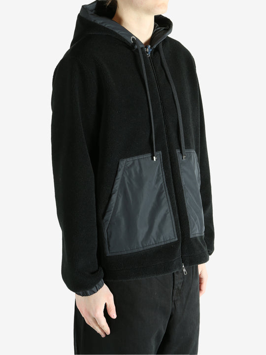 Black cardigan worn by a person, showing the cardigan fit