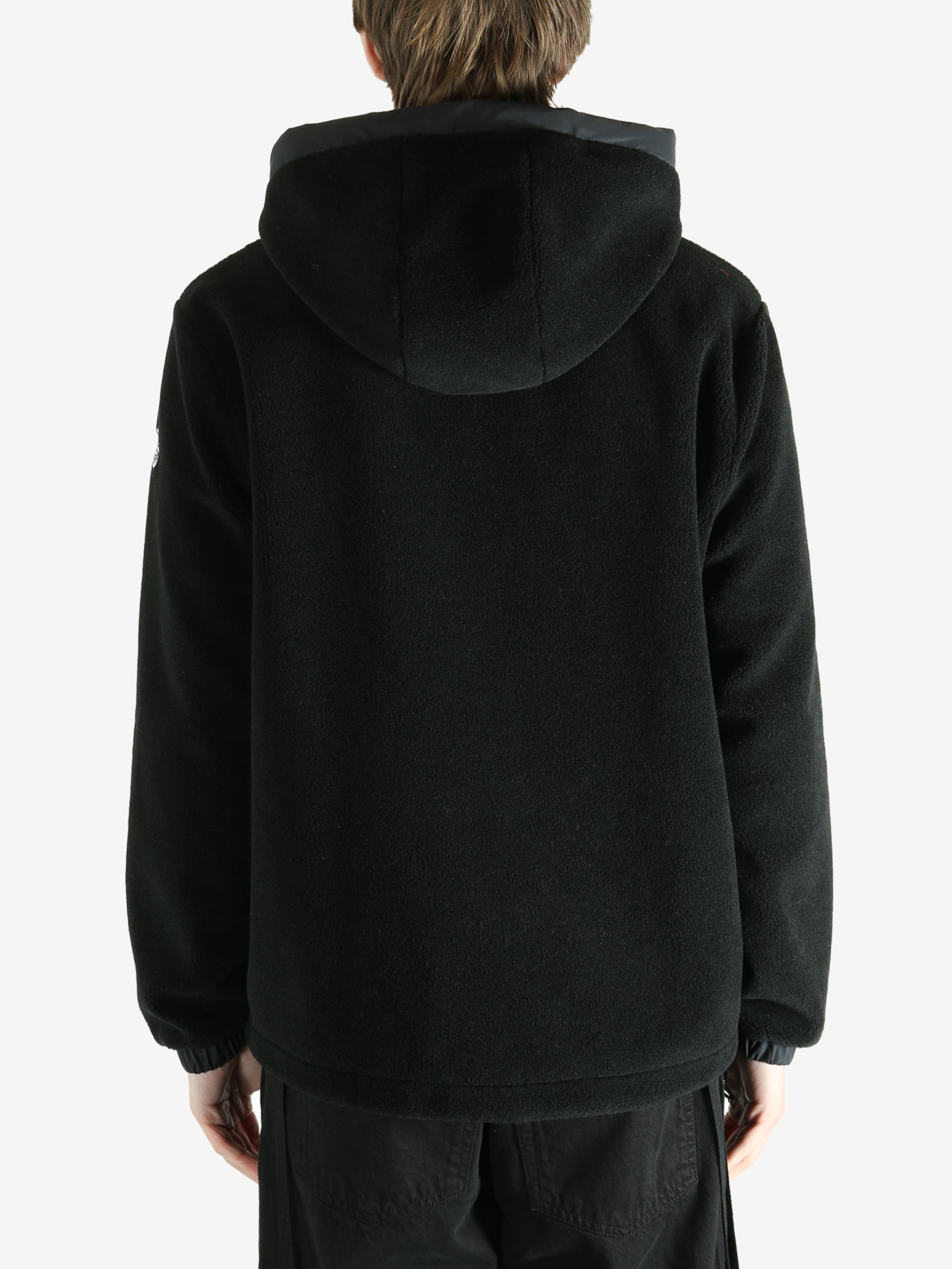 Black cardigan worn by a person, showing the cardigan fit