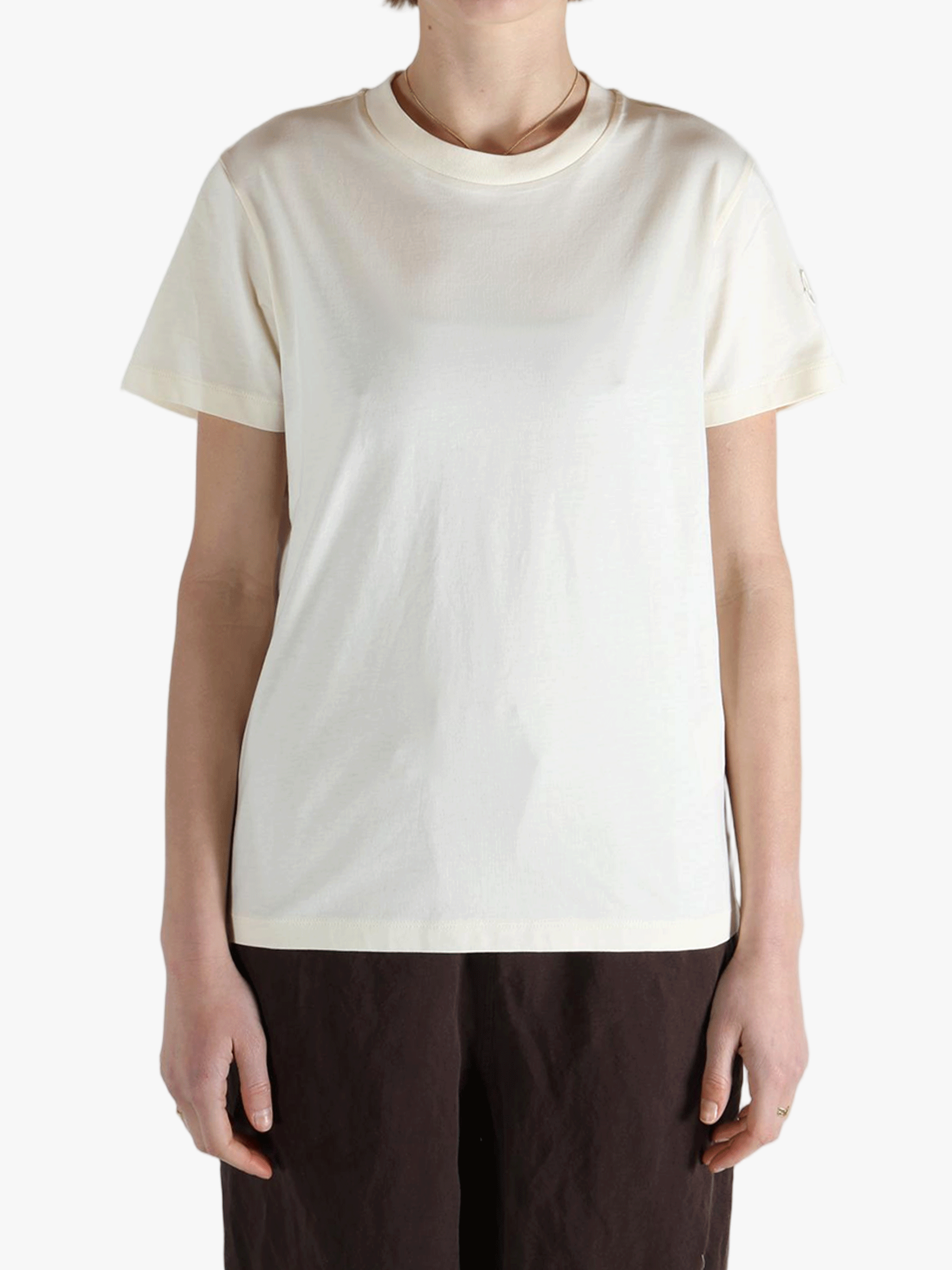 White t-shirt worn by a person, showing the shirt's fit