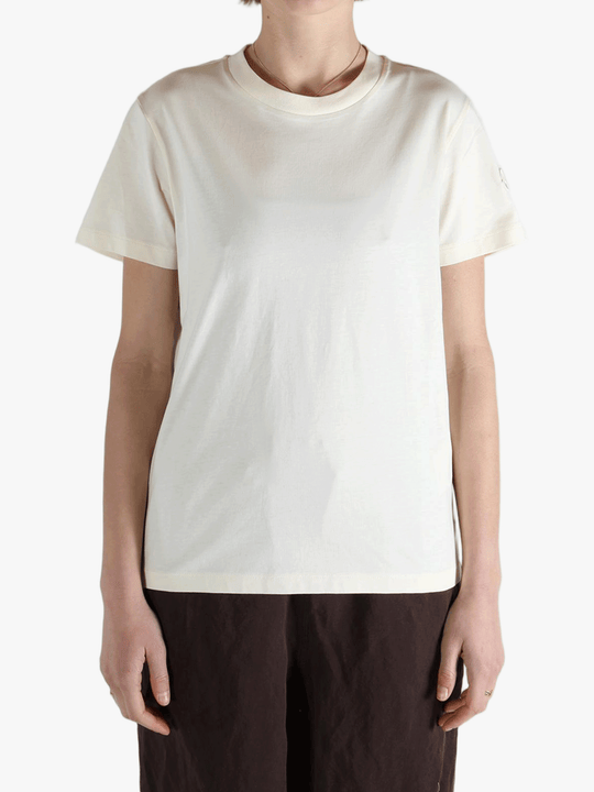 White t-shirt worn by a person, showing the shirt's fit