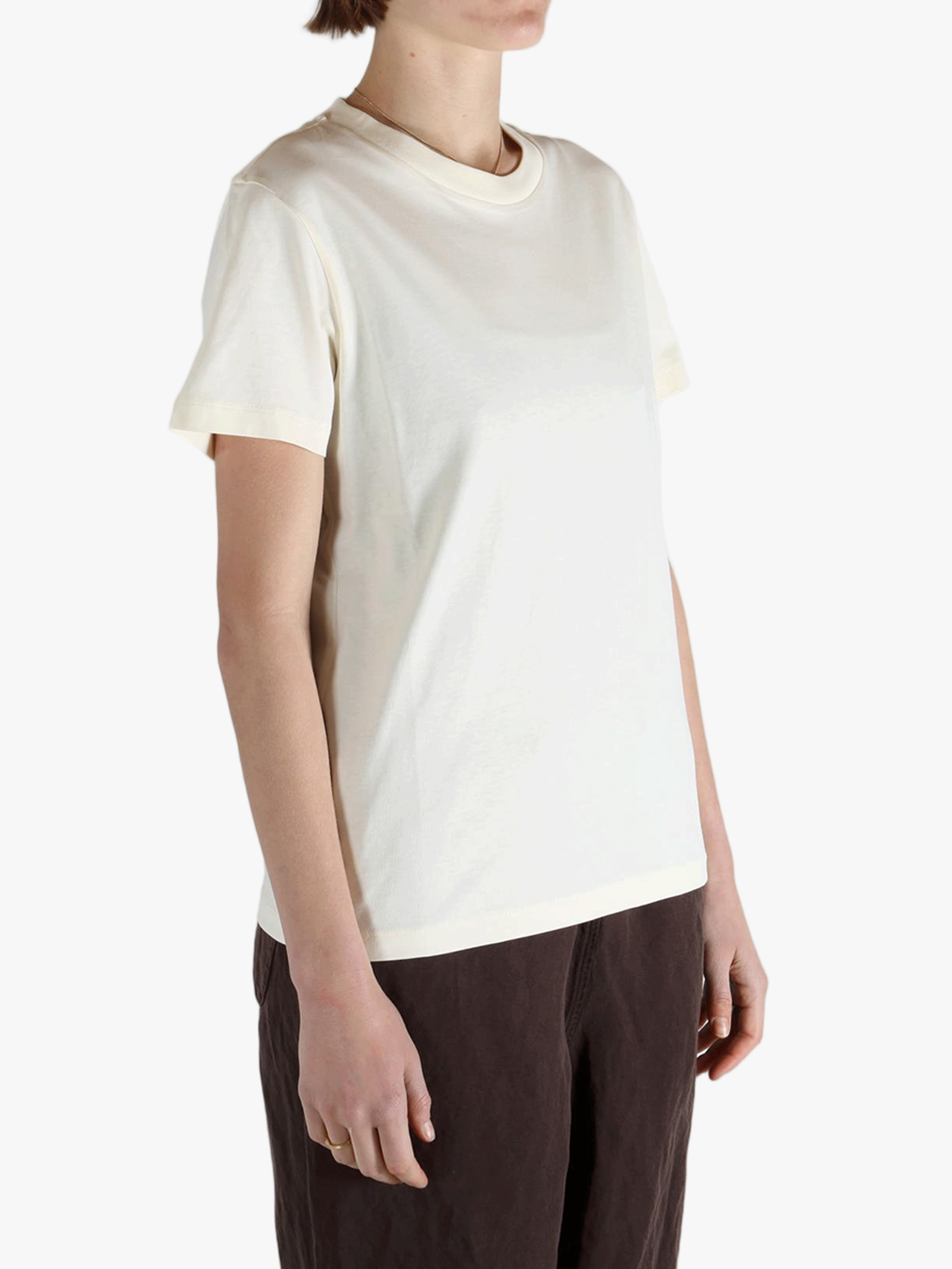 White t-shirt worn by a person, showing the shirt's fit