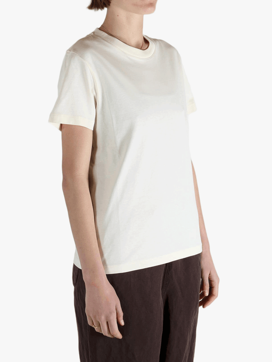 White t-shirt worn by a person, showing the shirt's fit