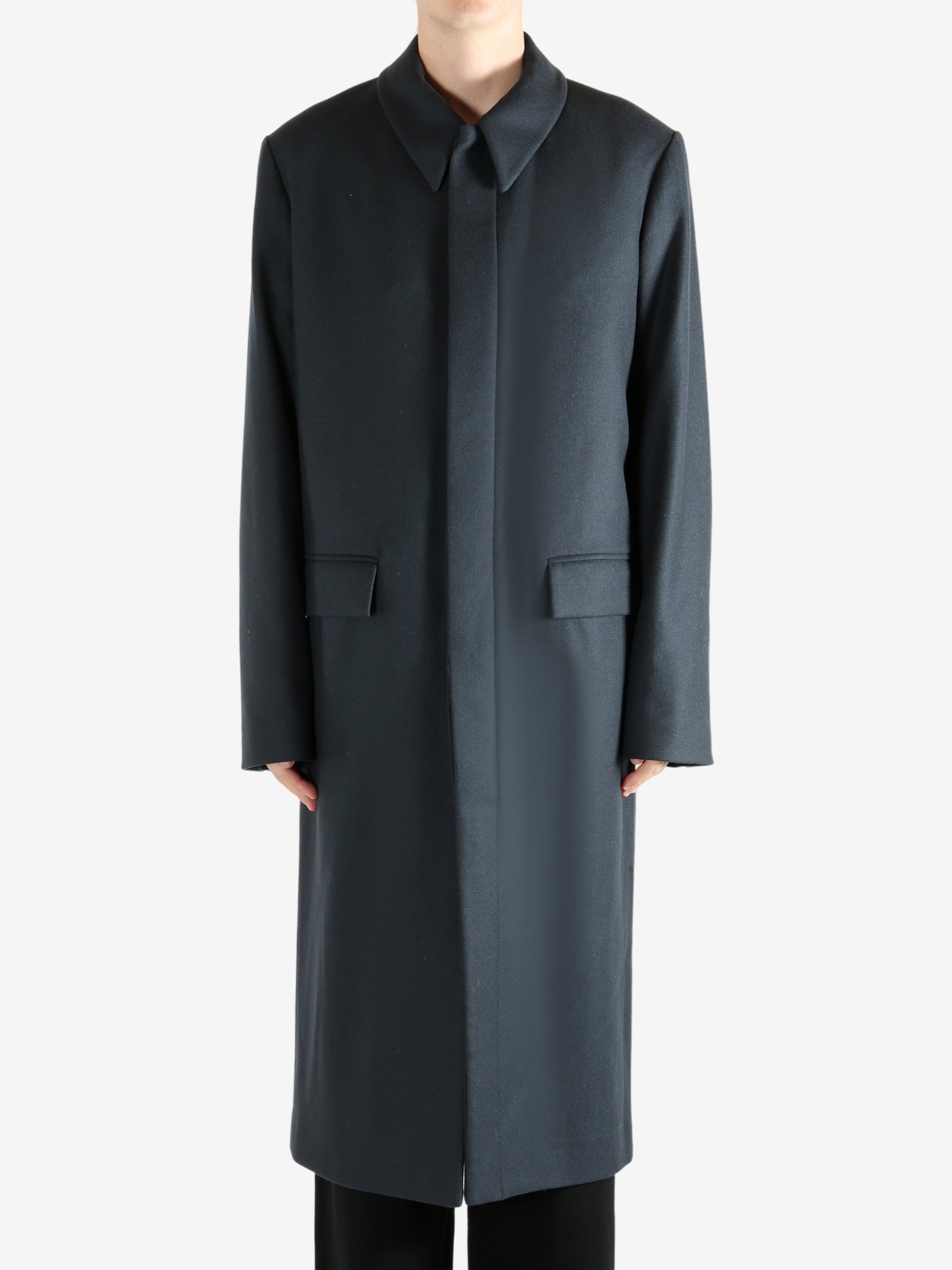 Black coat, worn by a person, showing the coat's fit