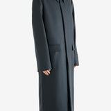 Black coat, worn by a person, showing the coat's fit