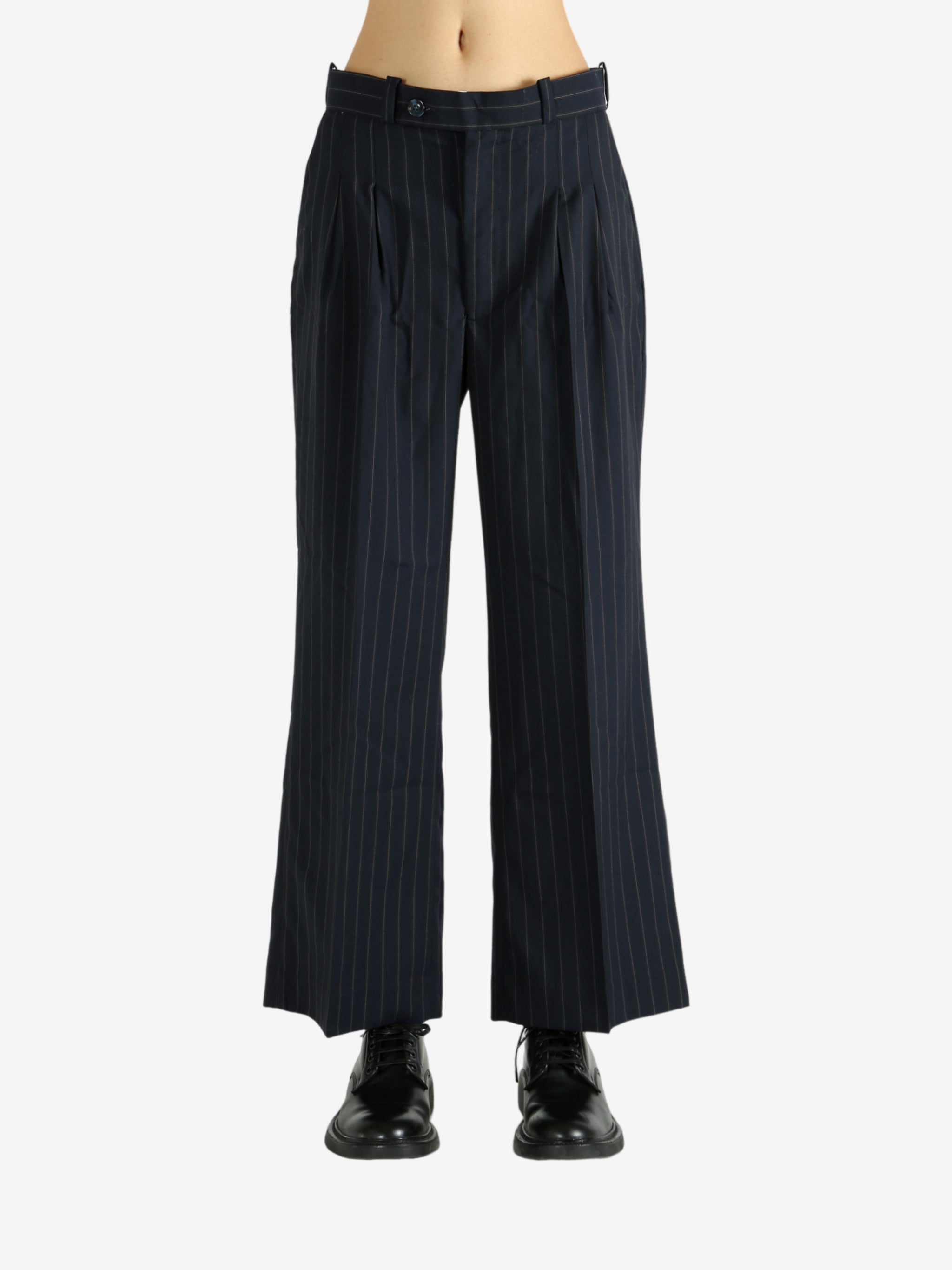 Black pants worn by a person, showing the pants' fit