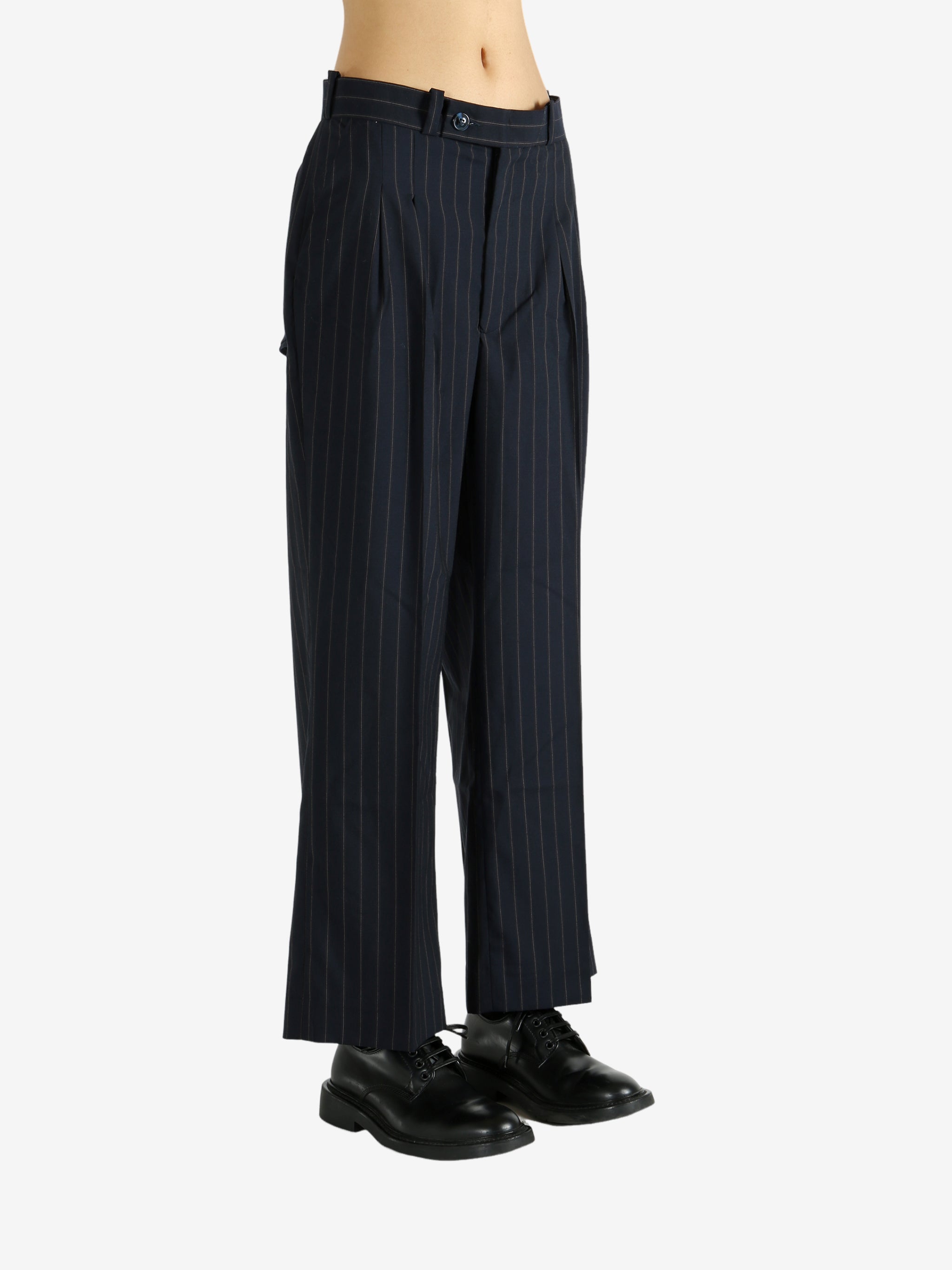 Black pants worn by a person, showing the pants' fit