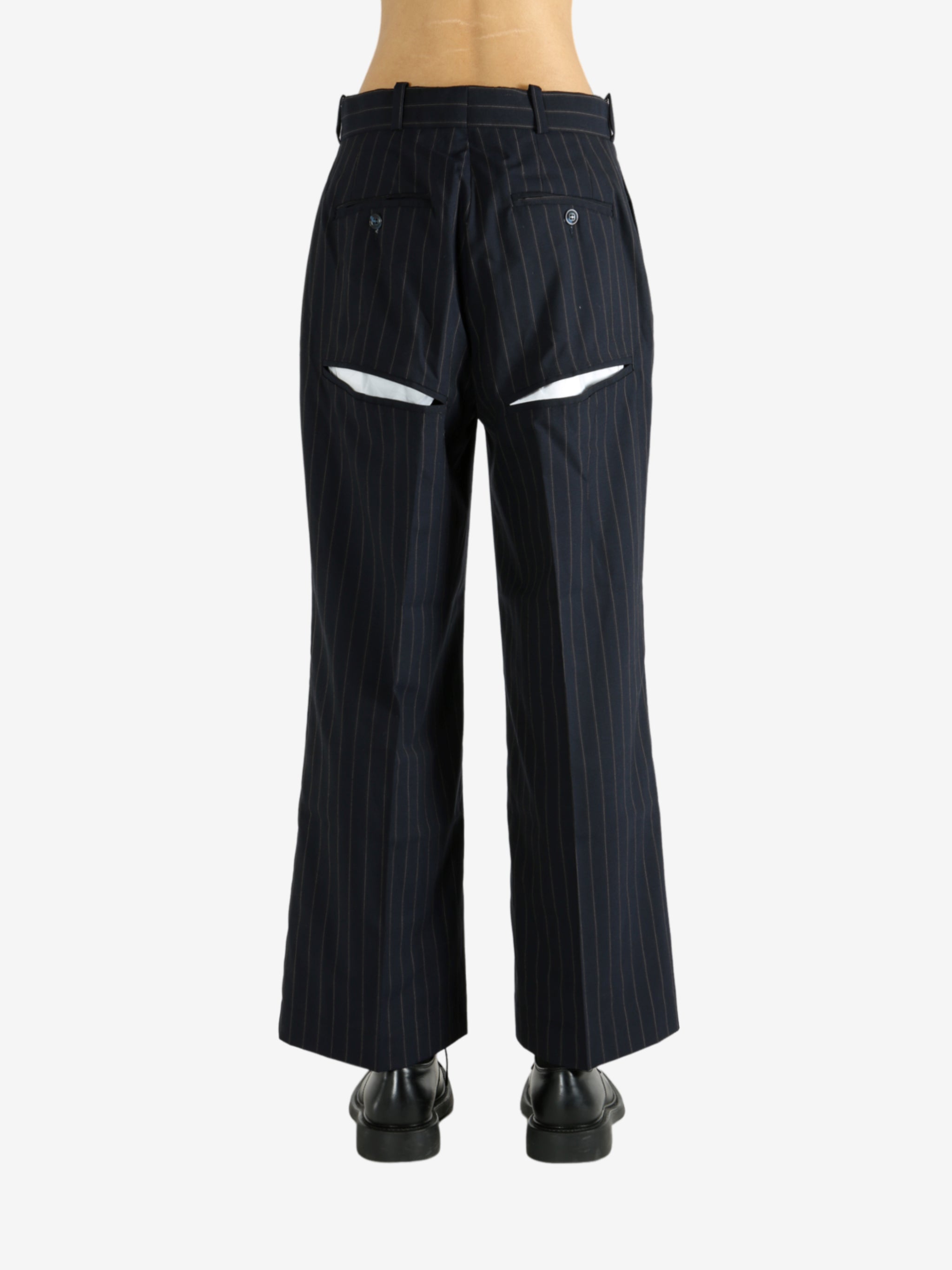 Black pants worn by a person, showing the pants' fit