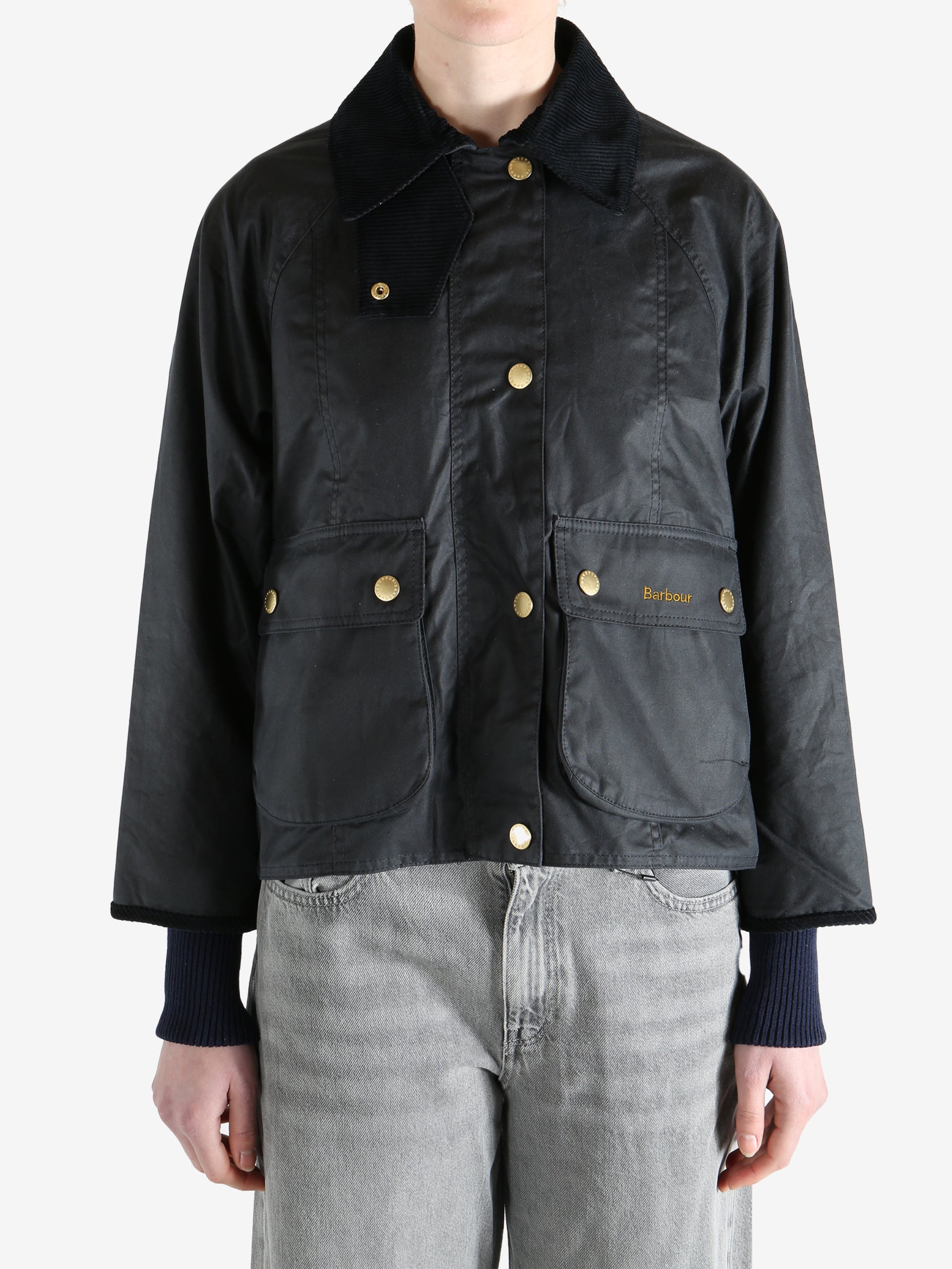 black jacket worn by a person, showing the jacket fit