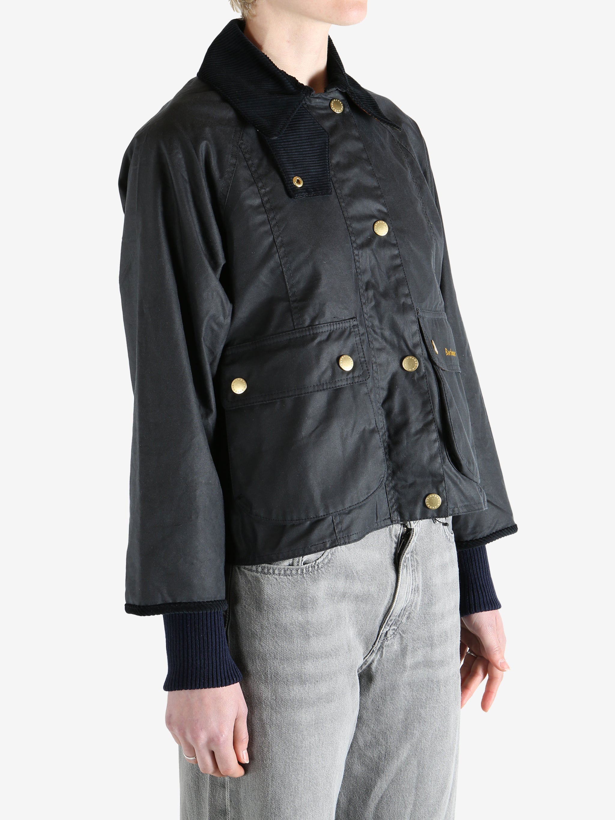 black jacket worn by a person, showing the jacket fit