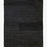 Back view of Lily Raskind Granny Square quilt, showing solid black patchwork backing and hand-stitched construction.