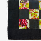 Floral patchwork detail on Lily Raskind quilt highlighting color, texture, and stitching.