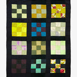 Colorful quilt with square patterns on black