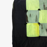 Detail view of Lily Raskind patchwork quilt showing green and black hand-dyed squares with hand-tied stitching.