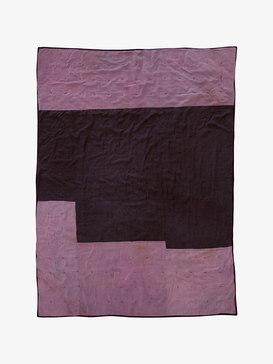 Back view of Lily Raskind hand-dyed silk blanket in Smoke Brush showing tonal patchwork layout in dark plum and mauve.