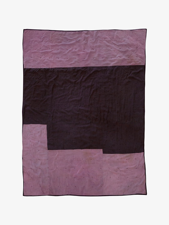 Back view of Lily Raskind hand-dyed silk blanket in Smoke Brush showing tonal patchwork layout in dark plum and mauve.