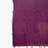 Close-up detail of Lily Raskind Smoke Brush hand-dyed silk blanket showing patchwork squares and hand-tied knots.