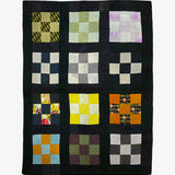 Handmade silk patchwork quilt by Lily Raskind with multicolor fabric squares