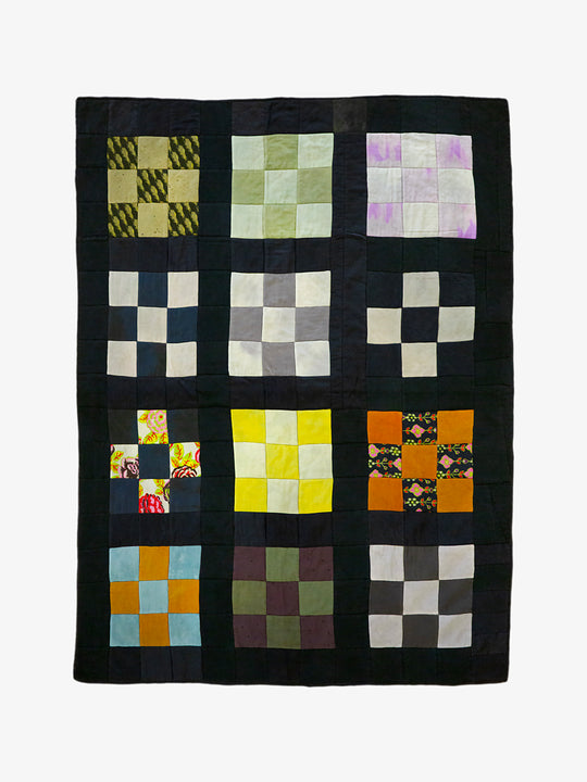 Handmade silk patchwork quilt by Lily Raskind with multicolor fabric squares