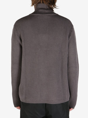 Grey knit worn by a person, showing the knit's fit