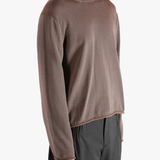 Brown knitwear worn by a person, showing the knitwear fit