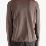 Brown knitwear worn by a person, showing the knitwear fit