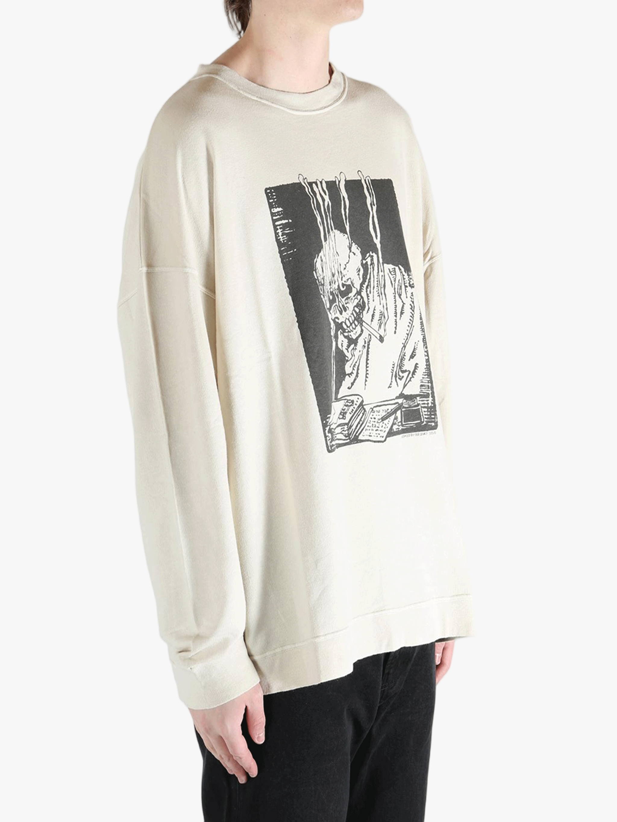 White sweatshirt worn by a person, showing the sweatshirt's fit