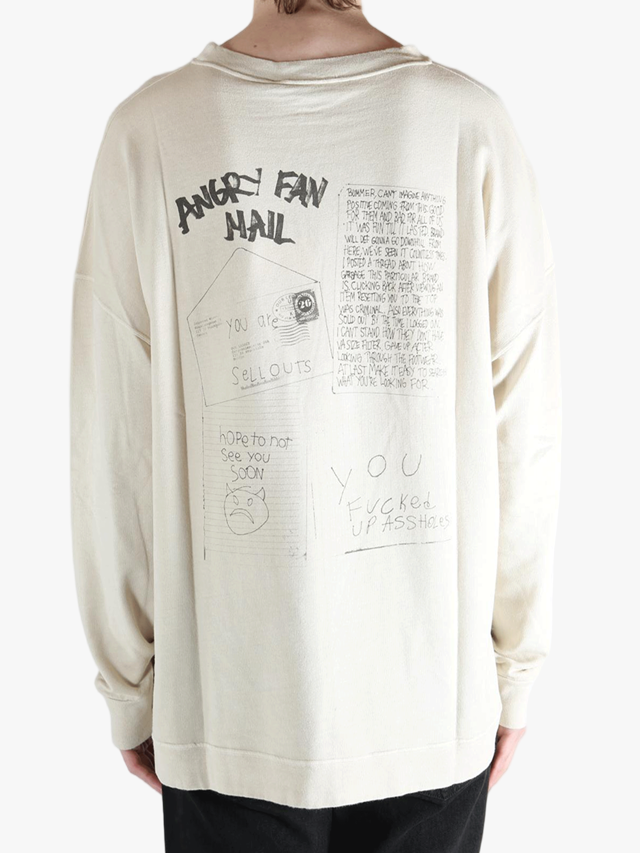 White sweatshirt worn by a person, showing the sweatshirt's fit