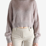 Tan knitwear worn by a person, showing the knitwear 's fit