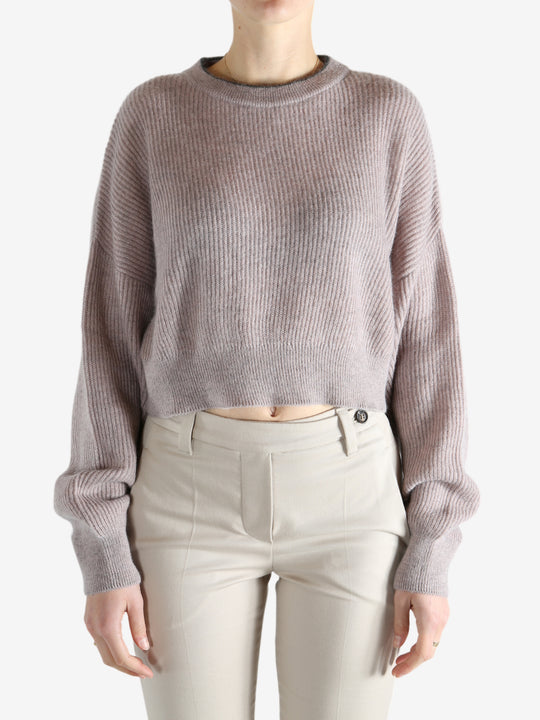 Tan knitwear worn by a person, showing the knitwear 's fit