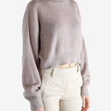 Tan knitwear worn by a person, showing the knitwear 's fit