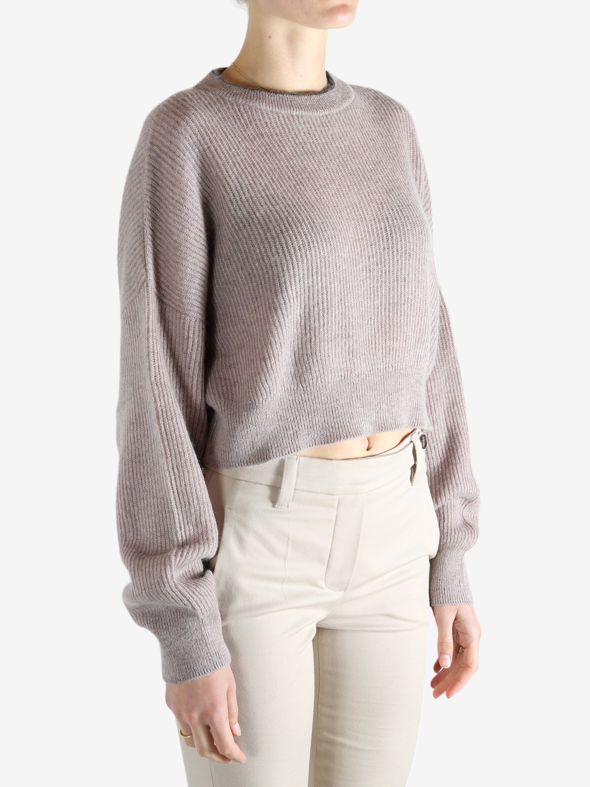 Tan knitwear worn by a person, showing the knitwear 's fit