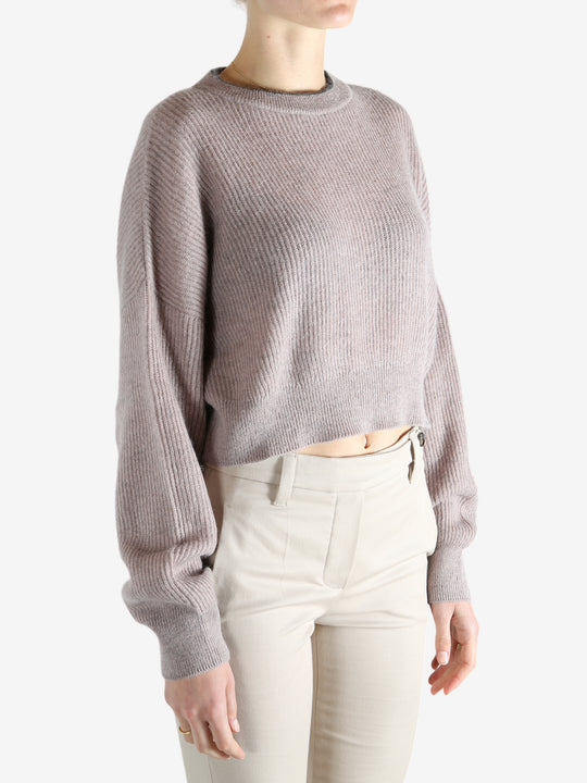 Tan knitwear worn by a person, showing the knitwear 's fit