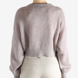 Tan knitwear worn by a person, showing the knitwear 's fit