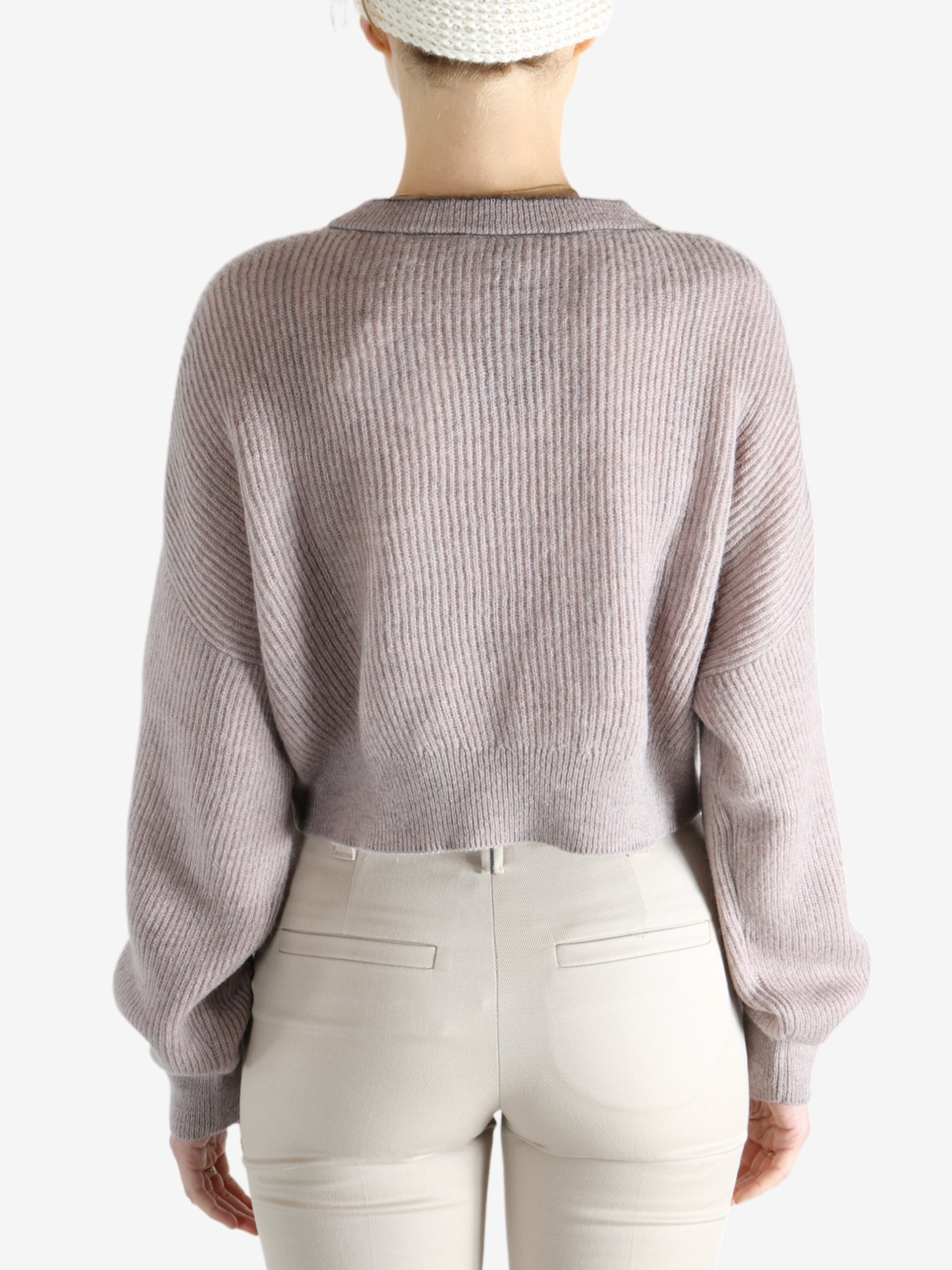 Tan knitwear worn by a person, showing the knitwear 's fit