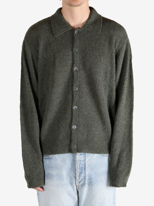 Green tops worn by a person, showing the tops fit