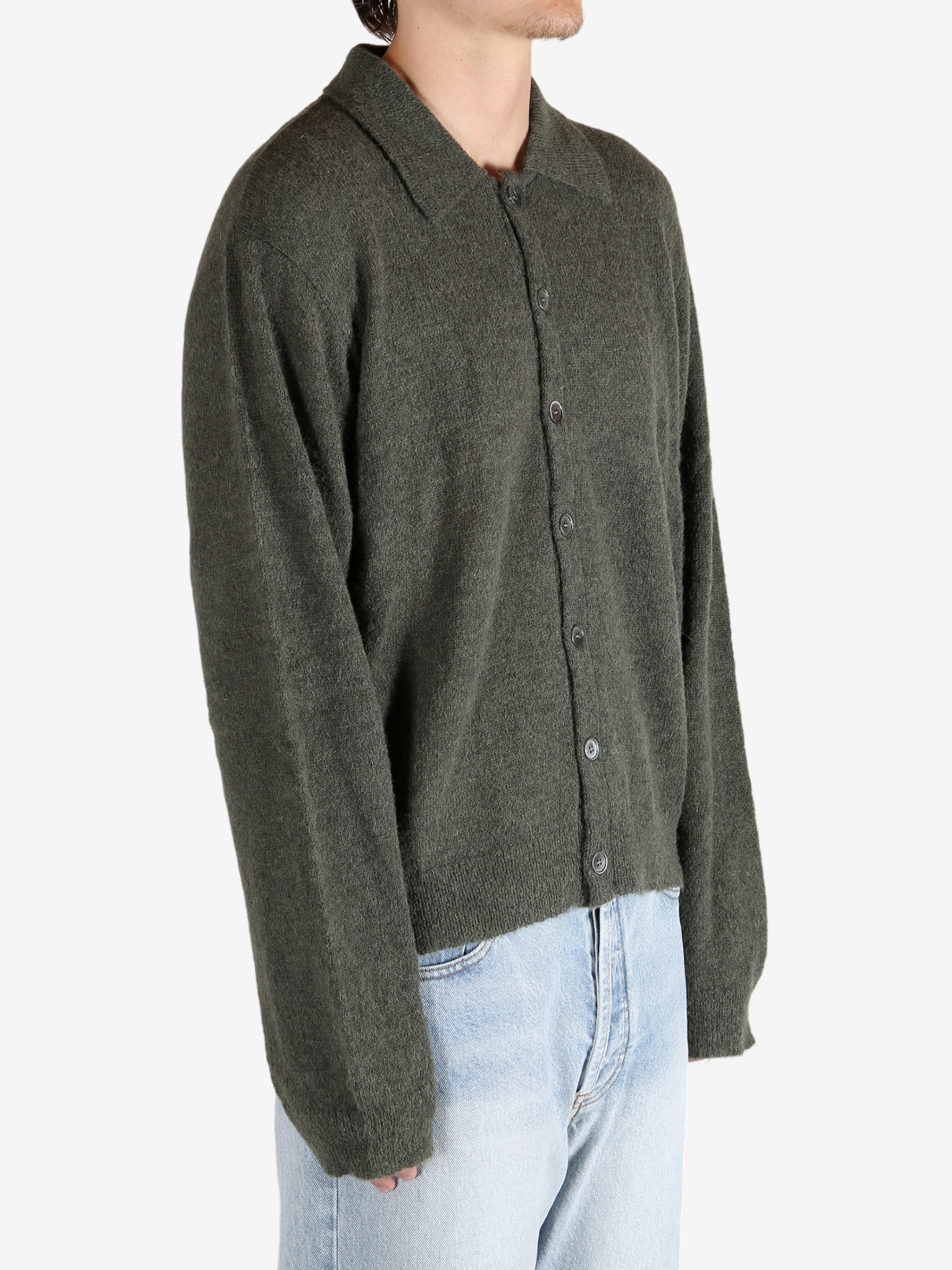 Green tops worn by a person, showing the tops fit