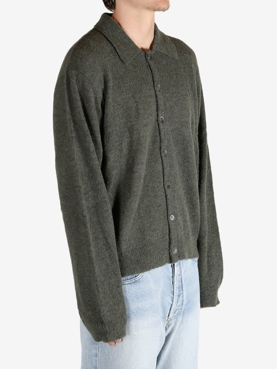 Green tops worn by a person, showing the tops fit