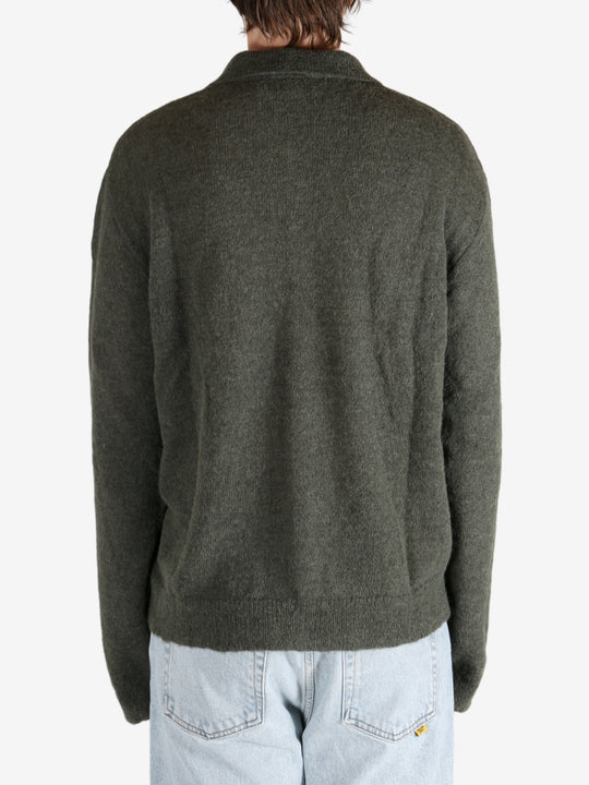 Green tops worn by a person, showing the tops fit