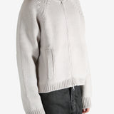 White cardigan worn by a person, showing the cardigan's fit