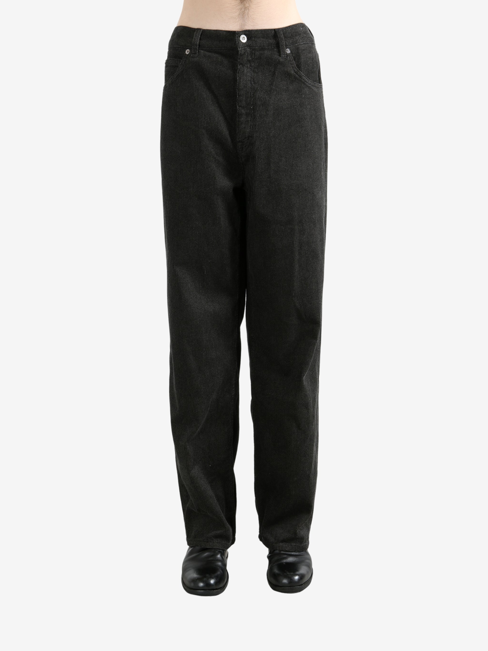 Black pants worn by a person, showing the pants's fit