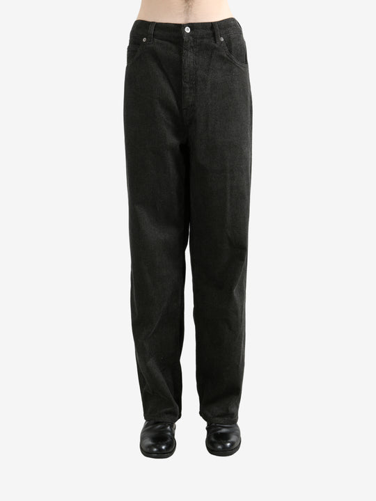 Black pants worn by a person, showing the pants's fit