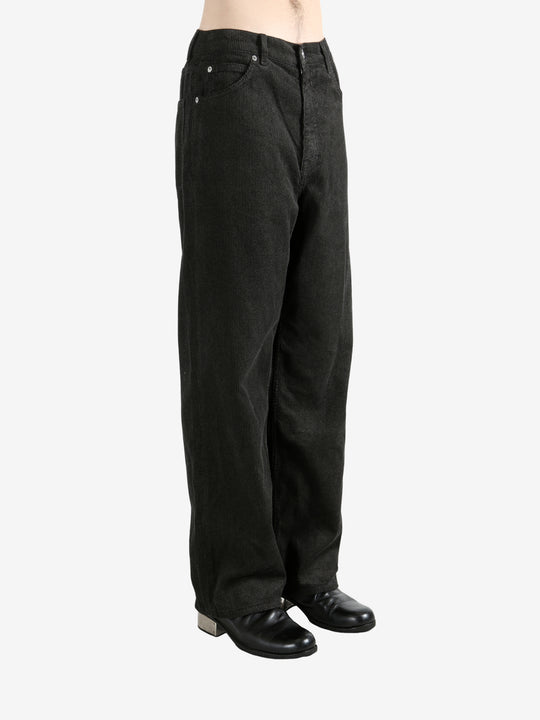 Black pants worn by a person, showing the pants's fit