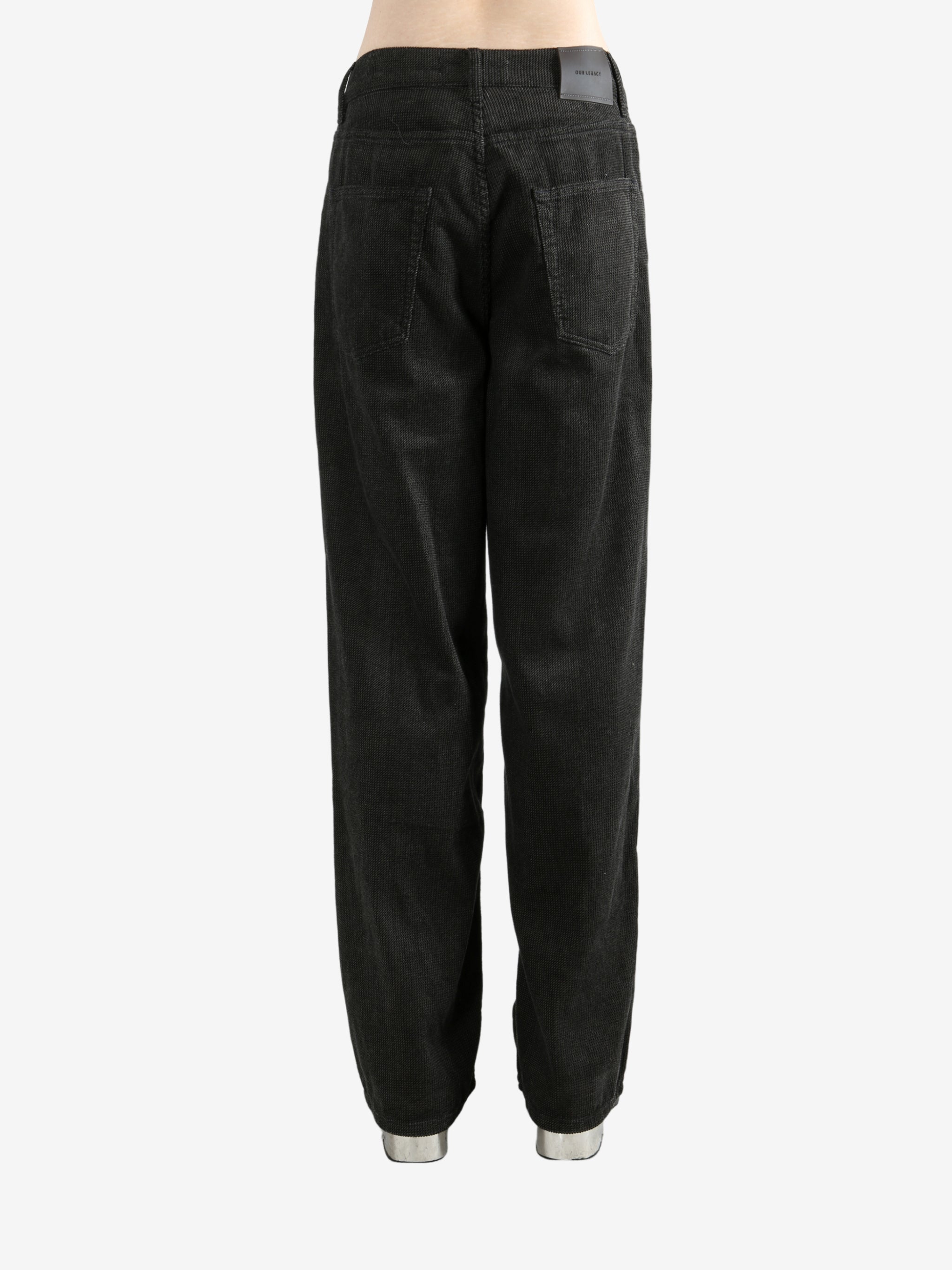 Black pants worn by a person, showing the pants's fit