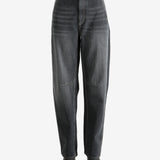 Black pants worn by a person, showing the pants' fit