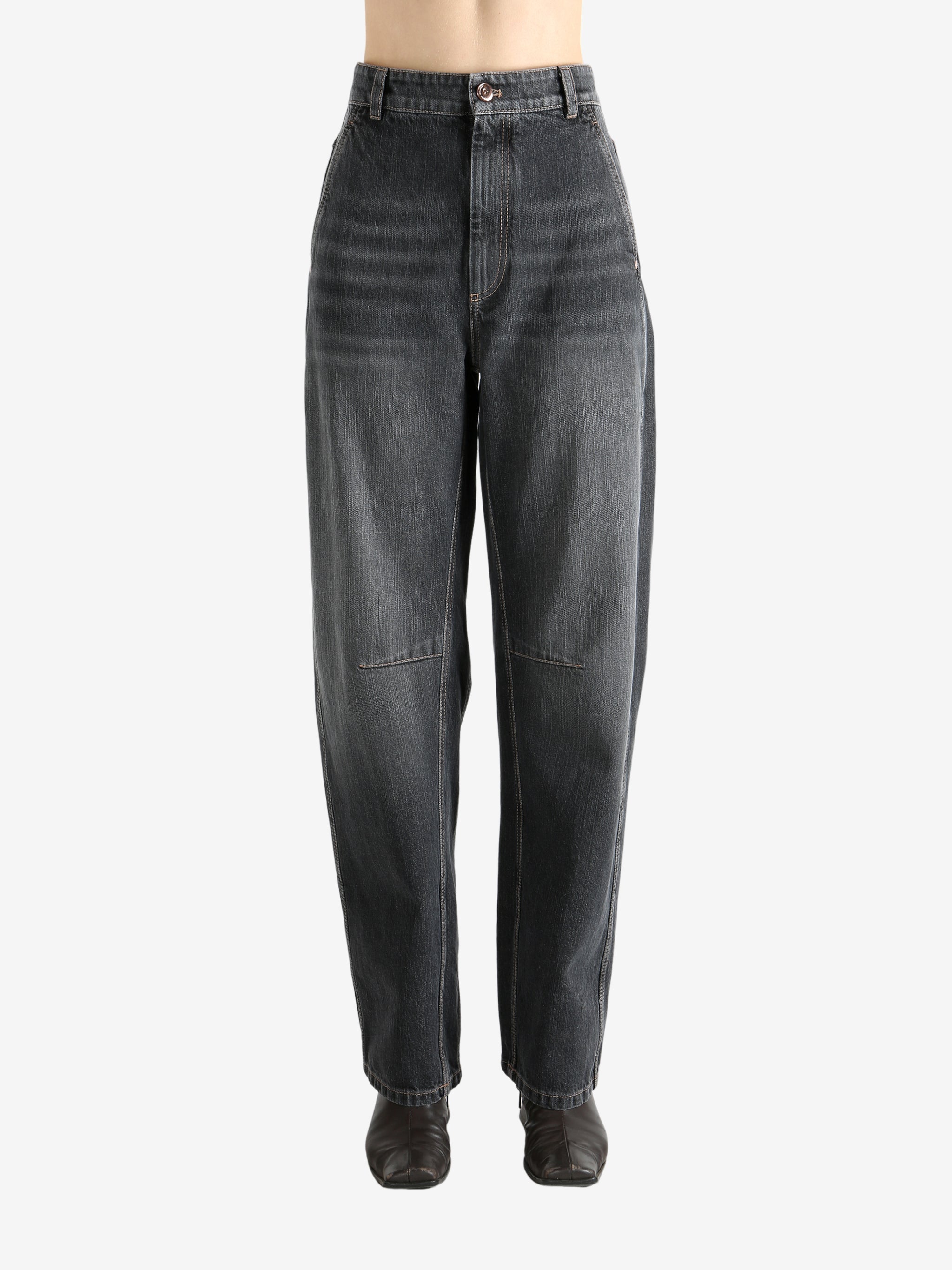 Black pants worn by a person, showing the pants' fit